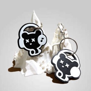 NFC and non-NFC black bear headphones keychains displayed on a white 3D printed mountain stand