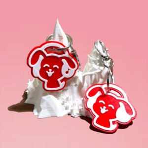 NFC and non-NFC red dog headphones keychains displayed on a white 3D printed mountain stand